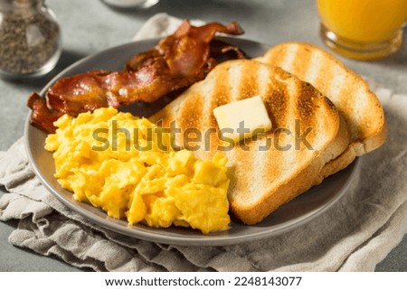 Homemade American Scrambled Egg Breakfast with Bacon and Toast Royalty-Free Stock Photo #2248143077