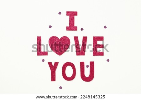 I love you lettering made of letters and heart on white background with confetti. Happy Valentines Day card.