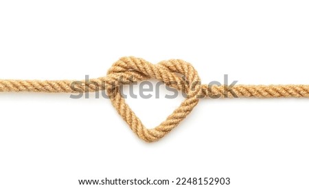 Rope with a heart shaped knot on white background Royalty-Free Stock Photo #2248152903
