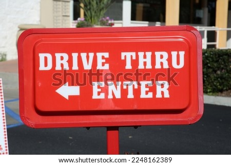 Drive Thru Enter. Fast Food Restaurant Entrance Sign. Room for text.  Drive Thru. Entrance Sign. Red Sign. Drive thru sign. White text written on a red background. 