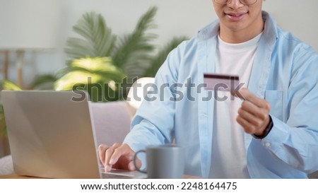 young man using tablet and credit card for online payment, E-commerce.
