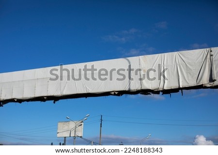 Billboard over road. White billboard above track. Place to place ad. Design over highway.