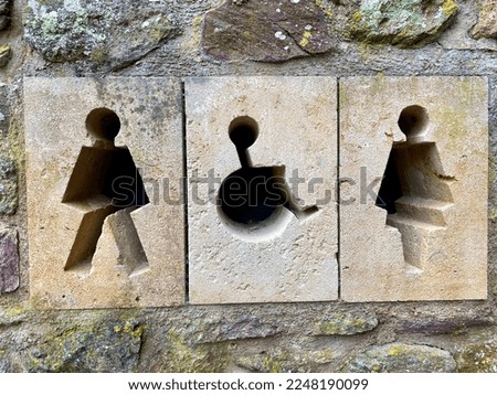 Stone Toilet sign, carved into wall. 