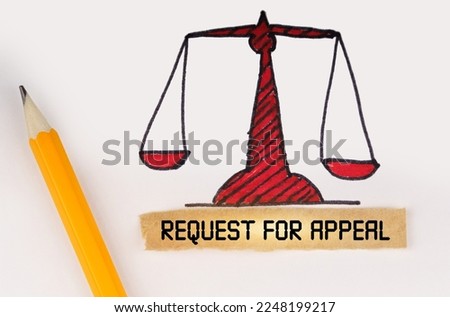 Legal concept. Next to the painted scales of justice lies a pencil and a strip of paper with the inscription - Request for Appeal Royalty-Free Stock Photo #2248199217