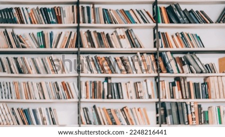 Bookshelves with books, textbooks in library, book store, at home. Abstract blurred background. Concept of learning, school, back to school, education