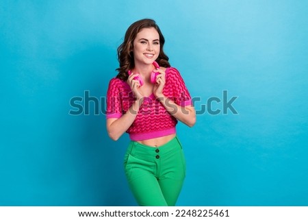 Photo of adorable positive lady wear pink clothes buy quality device nice sound good mood isolated on blue color background