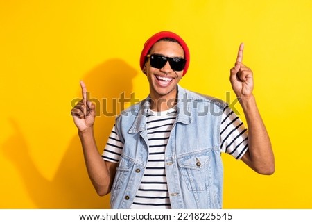Portrait of excited positive guy toothy smile point fingers up empty space isolated on yellow color background