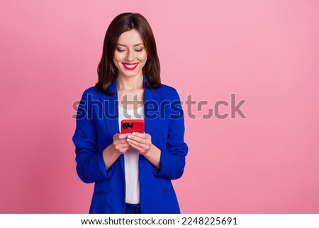 Photo of cheerful lady user wear blue stylish clothes hold telephone read news write post empty space isolated on pink color background