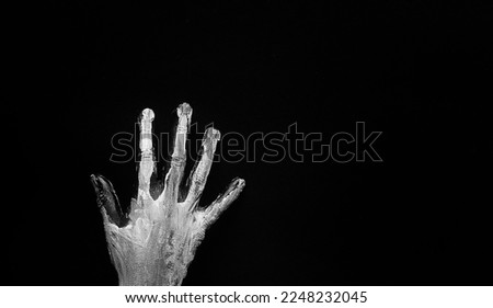 Painted female hand in black and white colors