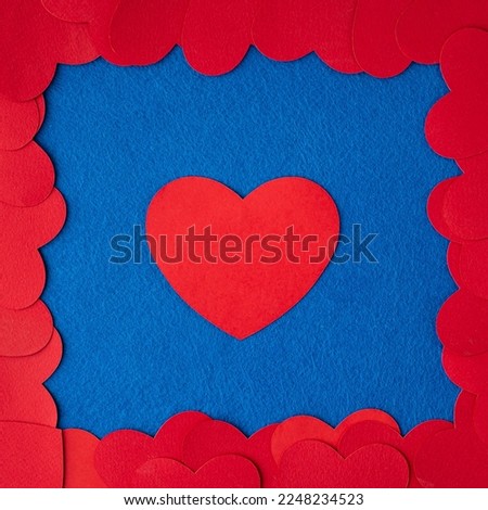 Red paper hearts frame on blue textured background with copy space. Love Concept image. Valentine's day, mother's day, birthday greeting cards, invitation