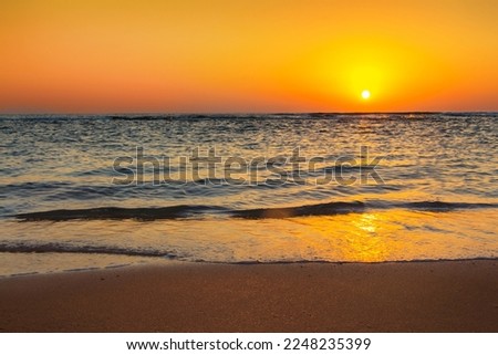 Beautiful Sunrise landscape with Bright yellow-orange sky. Morning sun rising over sea in clear cloudless sky. Nature scenic dawn background, texture for Design. Panoramic Natural Wallpaper, poster