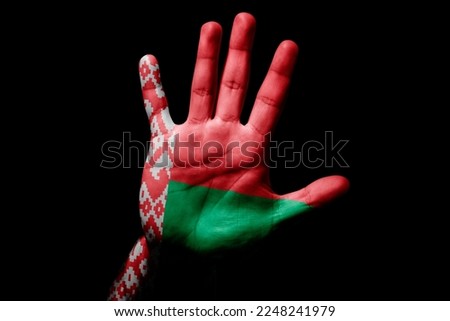 Rude man hand with flag of Belarus in stop sign to anger, discrimination, racism, abuse on black background.