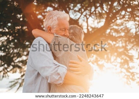 Head shot close up portrait happy grey haired middle aged woman snuggling to smiling older husband, enjoying tender moment at park. Bonding loving old family couple embracing, feeling happiness. Royalty-Free Stock Photo #2248243647