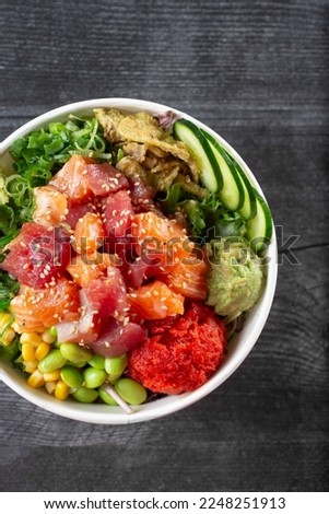 A top down view of a poke bowl, featuring salmon and ahi tuna. Royalty-Free Stock Photo #2248251913