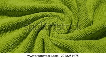 Green micro fiber in spiral folds (macro, top view, texture). Royalty-Free Stock Photo #2248251975