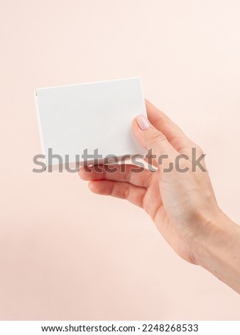 Blank White Product Package Box Mock-up. In a female hand. Container, Packaging Template on white .White cardboard box. Royalty-Free Stock Photo #2248268533
