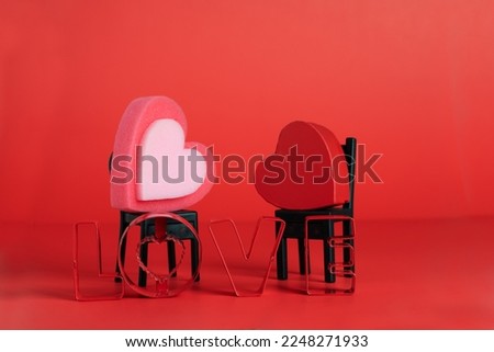 concept of Valentine's Day, two hearts on two home chairs and the word LOVE. Together forever.