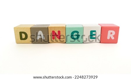 Danger symbol. Concept word danger on colorful wooden cubes. Danger word on colorful wooden blocks with copy space background.