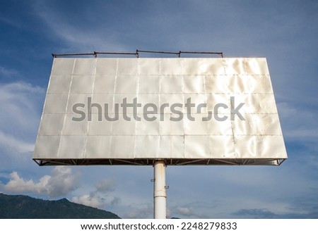 Blank billboard ready for new advertisement with blue sky background. Mock up.