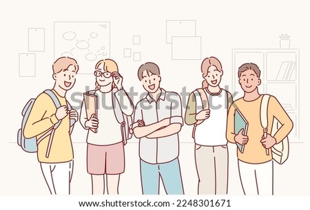 cheerful smiling diverse schoolchildren standing posing in classroom holding notebooks and backpacks looking at camera. Hand drawn style vector design illustrations. Royalty-Free Stock Photo #2248301671