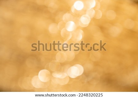 Gold bokeh background, Blurred photos of shiny lights,The art of golden circular light gives a sense of luxury.