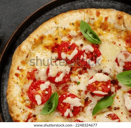 Freshly baked pizza on dark background. Tasty homemade food concept. Top view, copy space