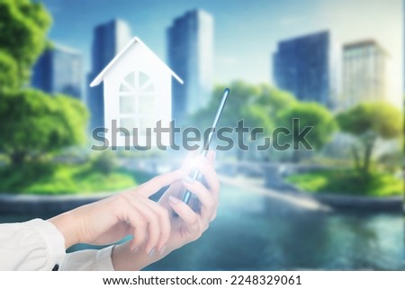 real estate online, property agency, booking apartments via internet, hand with a phone on the background of a modern city