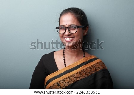 Portrait of a happy smiling woman of Indian origin wearing traditional dress Sari