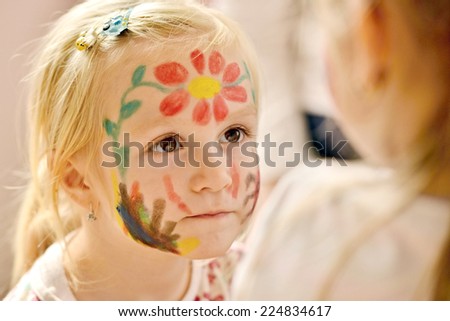 Little girl with painting face as a butterfly
