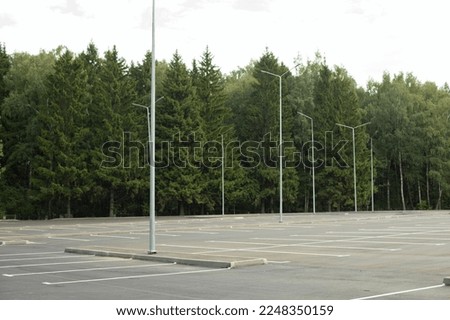Empty parking in summer. Parking in park. Parking place. Asphalt area.