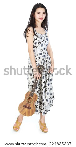 Attractive asian girl playing ukulele