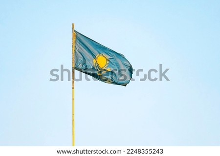 Kazakhstan flag on blue sky background. close up waving flag of Kazakhstan. flag symbols of Kazakhstan.