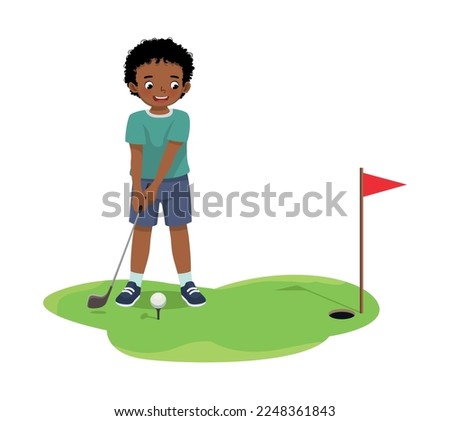 Cute little African boy playing golf ready to hit ball aiming at the hole