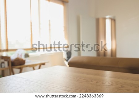 wood table and blurry room background Royalty-Free Stock Photo #2248363369