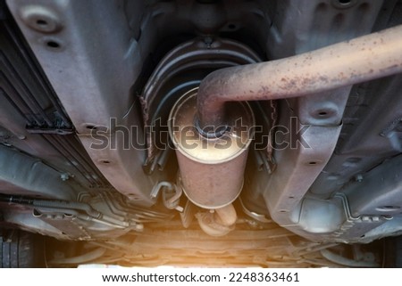 Close-up of catalytic converter in automobile exhaust system. Royalty-Free Stock Photo #2248363461