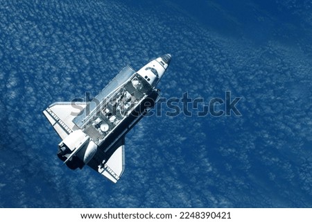 Space shuttle above the surface of the Earth. Elements of this image furnished by NASA. High quality photo