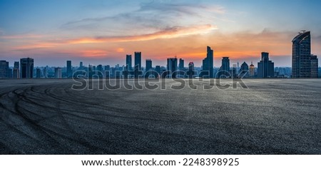 Asphalt road and city skyline with modern buildings in Shanghai at sunset, China. Panoramic view.