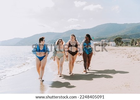 Group of beautiful plus size women with swimwear bonding and having fun at the beach - Group of curvy female friends enjoying summertime at the sea, concepts about body acceptance, body positive 