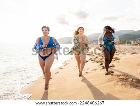 Group of beautiful plus size women with swimwear bonding and having fun at the beach - Group of curvy female friends enjoying summertime at the sea, concepts about body acceptance, body positive 
