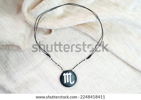 Scorpio necklace on a white background.