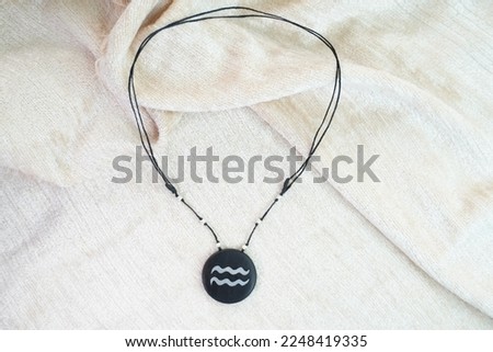 Aquarius necklace on a white background.