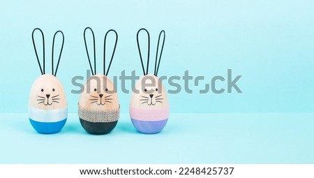 Easter bunny or rabbit group, holiday background and greeting card, painted wooden egg 