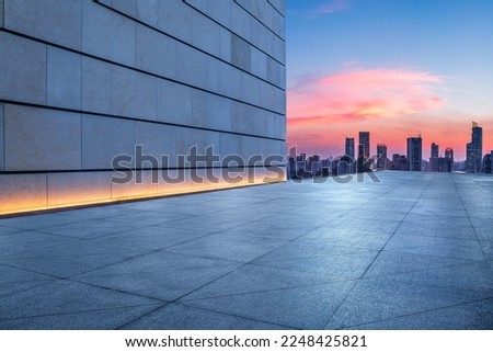 Empty square floor and wall with city skyline at sunset in Shanghai, China.