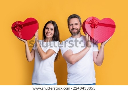 couple holding valentine love present in studio. valentine holiday love couple with present.