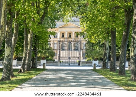 Chateau Margaux in the tree tunnel, Bordeaux, France Royalty-Free Stock Photo #2248434461
