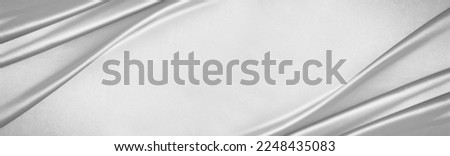 White light gray silvery silk satin. Draped fabric. Silver color. Luxury background with space for design. template. Flat lay, top view table. wide banner. Panoramic. Soft folds, creases. Royalty-Free Stock Photo #2248435083