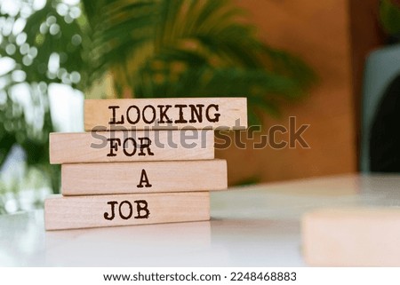 Wooden blocks with words 'Looking For a Job'.