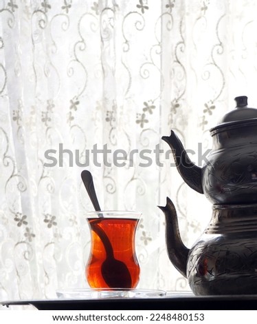Turkish tea consept with vintage copper kettle on backlight.    