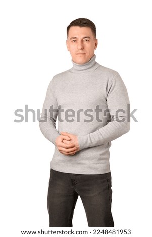Young man wearing gray turtleneck sweater and jeans stands on the white background Royalty-Free Stock Photo #2248481953