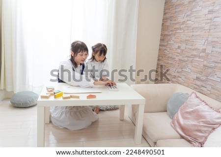 
Child drawing with mother in the room